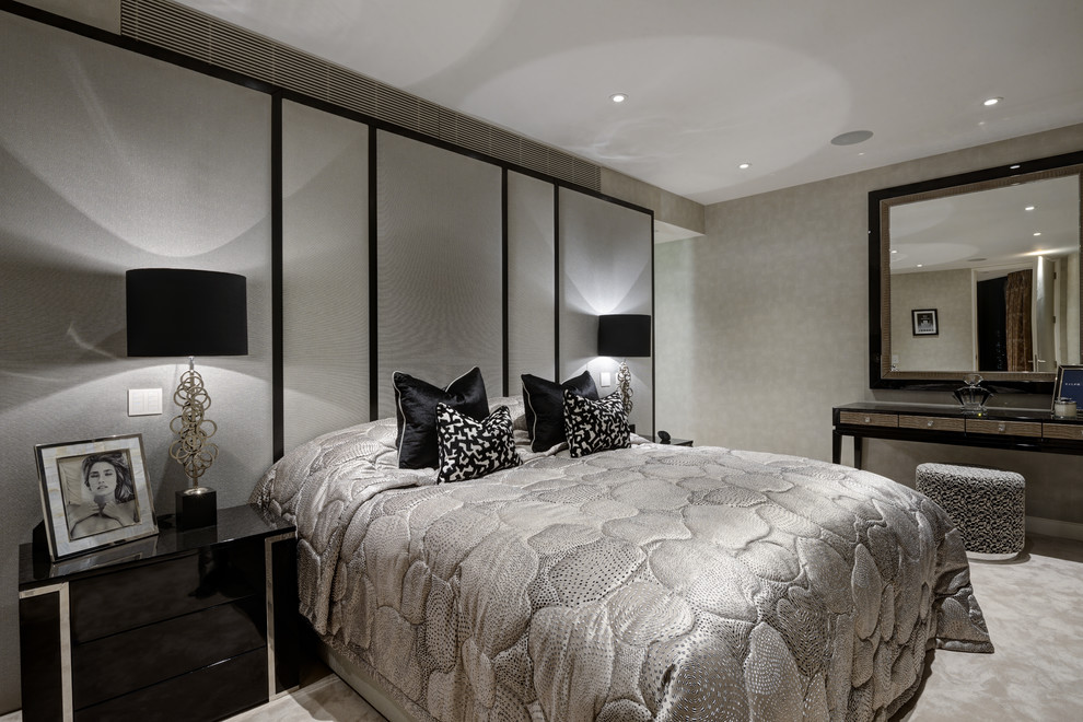 Contemporary bedroom in London with grey walls, carpet and grey floors.