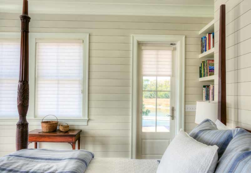 Inspiration for a medium sized nautical master bedroom in Charleston with white walls and light hardwood flooring.