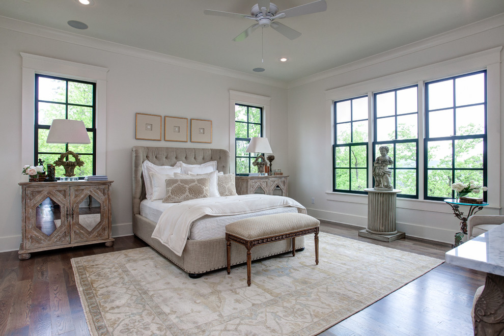 Example of a mid-sized classic master medium tone wood floor bedroom design in Little Rock with white walls and no fireplace