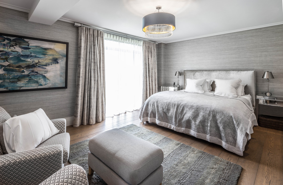 Photo of a traditional grey and brown and grey and silver bedroom in London with grey walls, medium hardwood flooring and brown floors.
