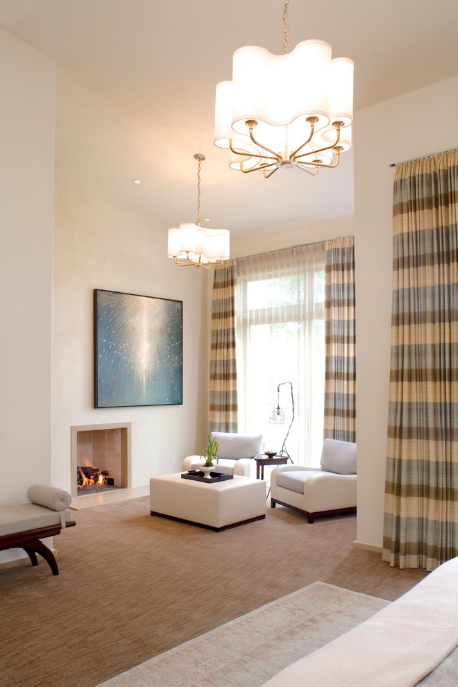 Photo of a contemporary master bedroom in Austin with beige walls, carpet and a standard fireplace.