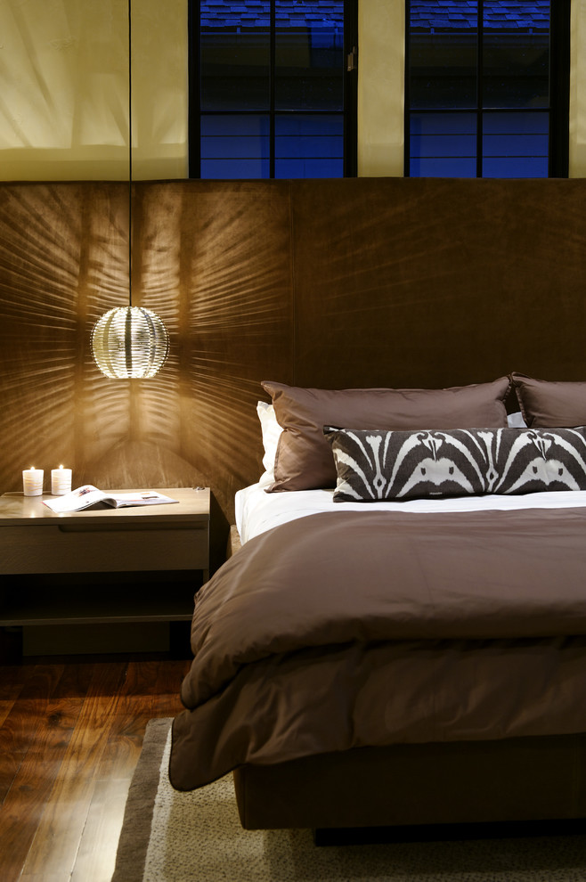 Inspiration for a large rustic master medium tone wood floor bedroom remodel in Denver with beige walls