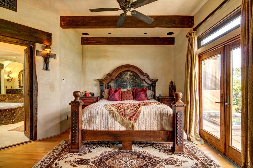 Inspiration for a large southwestern master medium tone wood floor bedroom remodel in San Diego with beige walls