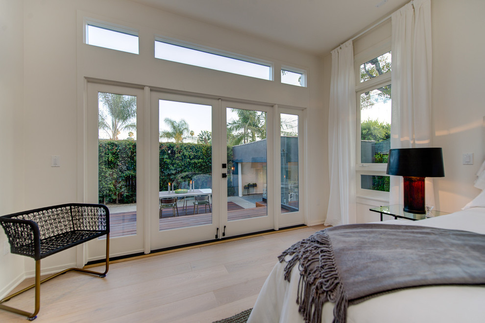 Photo of a medium sized contemporary master bedroom in Los Angeles with white walls, lino flooring and no fireplace.