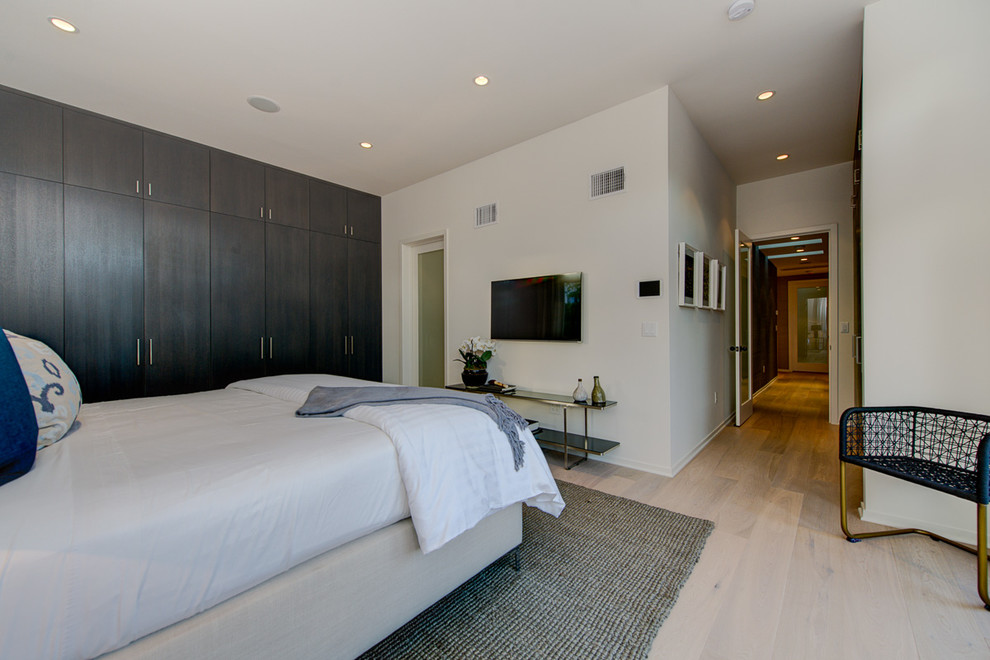 Example of a mid-sized trendy linoleum floor bedroom design in Los Angeles with white walls and no fireplace