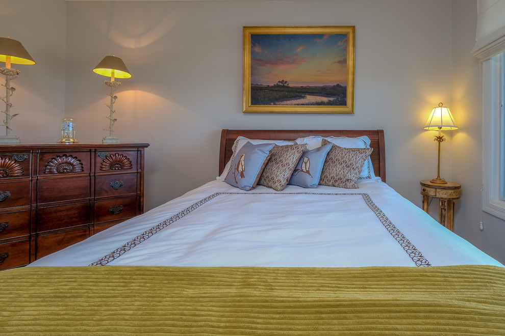 Example of a mid-sized beach style guest medium tone wood floor and brown floor bedroom design in Atlanta with beige walls
