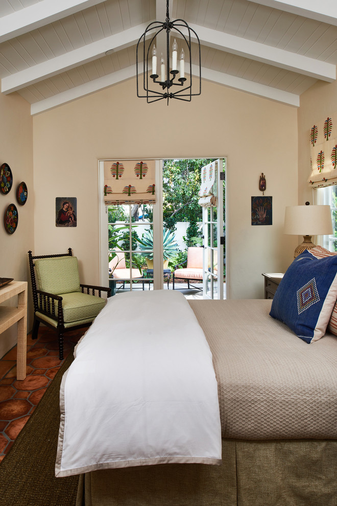 Example of a mid-sized tuscan guest terra-cotta tile and orange floor bedroom design in Los Angeles with beige walls and no fireplace