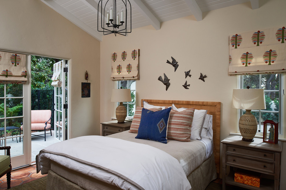 Medium sized mediterranean guest bedroom in Los Angeles with beige walls, terracotta flooring, no fireplace and orange floors.