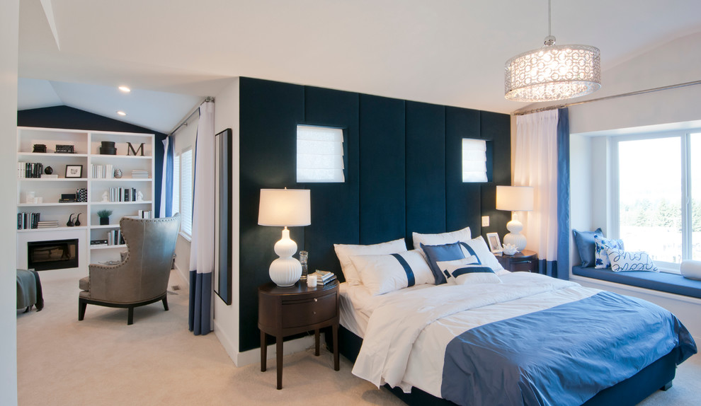 Design ideas for a large contemporary master bedroom in Vancouver with blue walls, carpet, a standard fireplace, a wooden fireplace surround and beige floors.