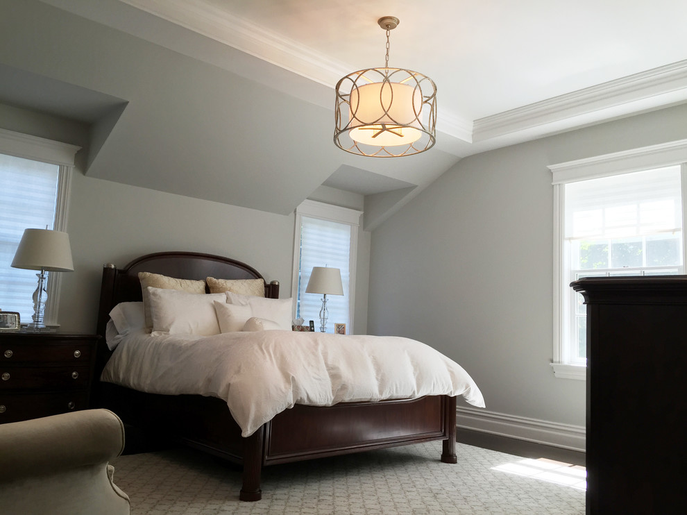 Medium sized classic master bedroom in New York with grey walls and dark hardwood flooring.