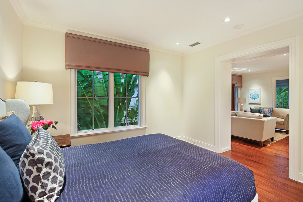 Bedroom - large tropical guest medium tone wood floor bedroom idea in Tampa with beige walls