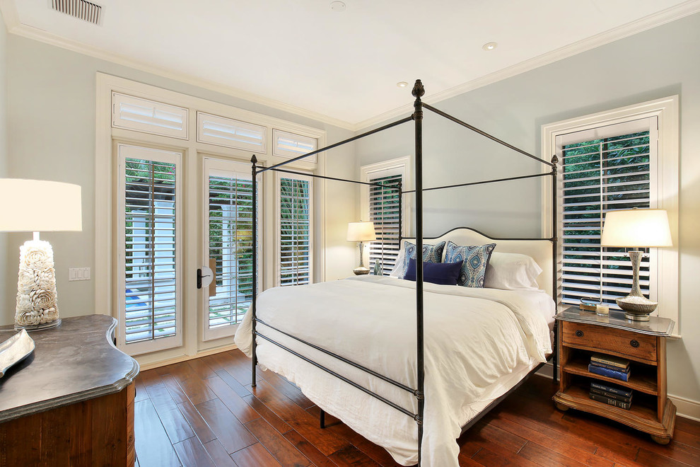 Design ideas for a large world-inspired guest bedroom in Tampa with blue walls, medium hardwood flooring and no fireplace.