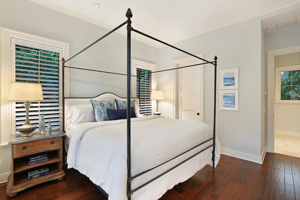 Design ideas for a large world-inspired guest bedroom in Tampa with blue walls and medium hardwood flooring.