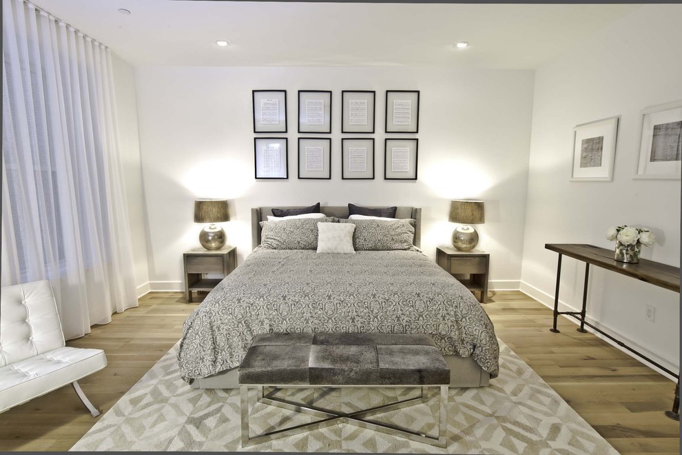 Bedroom - large industrial loft-style light wood floor bedroom idea in New York with white walls