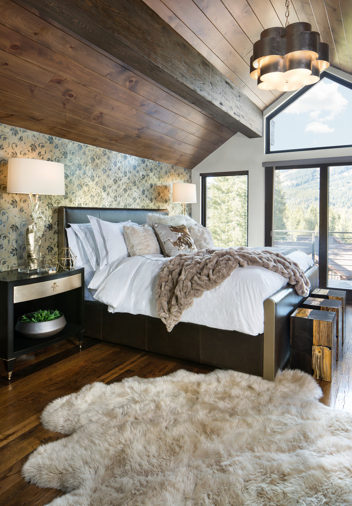 Inspiration for a rustic medium tone wood floor and brown floor bedroom remodel in Denver with white walls