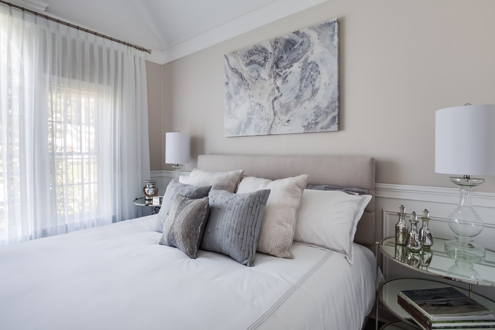 Classic guest bedroom in New York with beige walls and a dado rail.