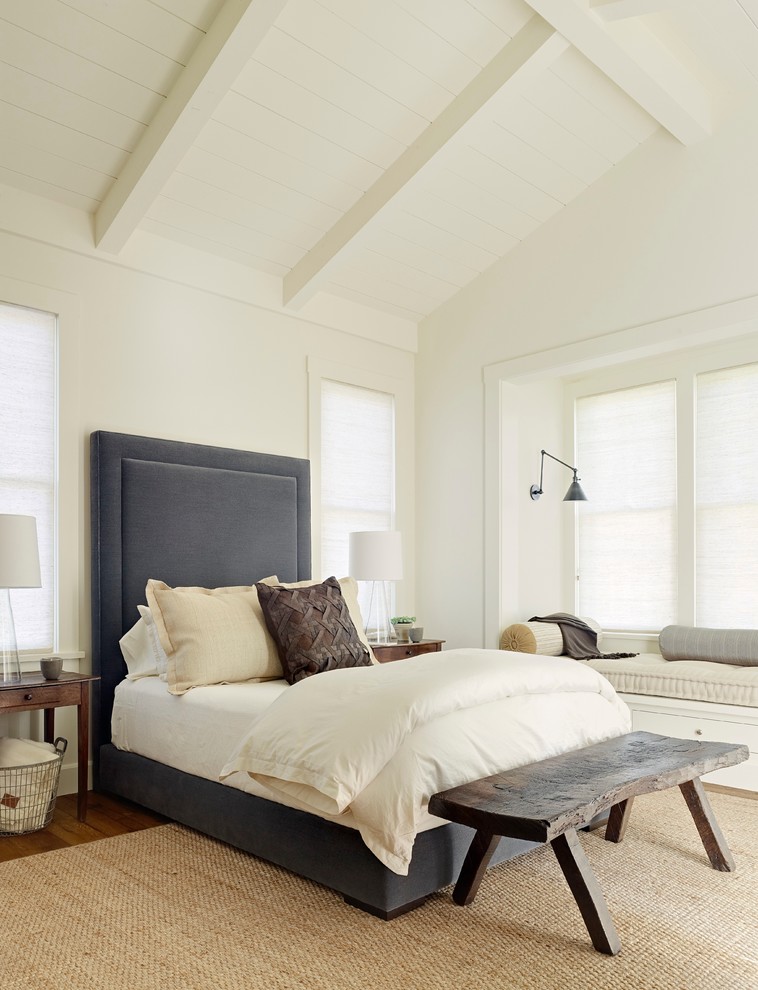 Cottage medium tone wood floor bedroom photo in San Francisco with white walls