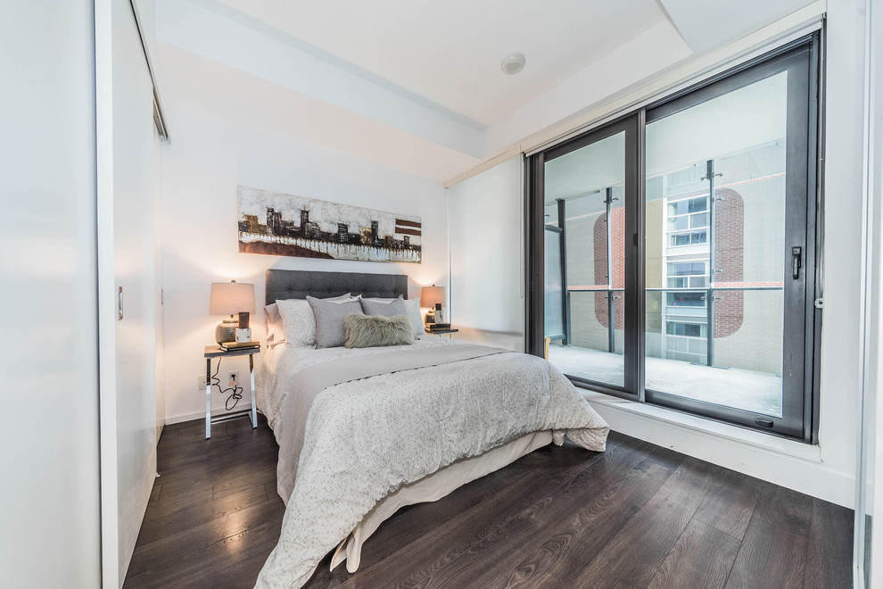 Medium sized contemporary guest bedroom in Toronto with white walls, dark hardwood flooring, no fireplace and brown floors.