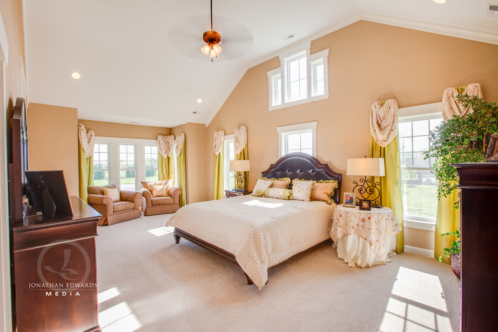 Immagine di una grande camera matrimoniale country con pareti beige e moquette
