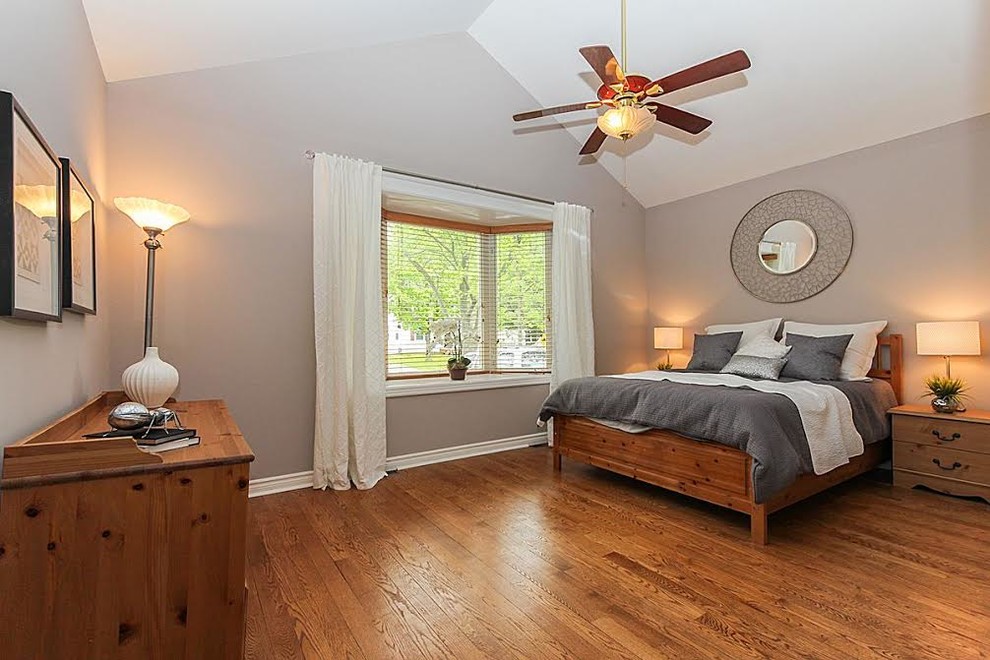 Photo of a medium sized contemporary master bedroom in Montreal with light hardwood flooring.