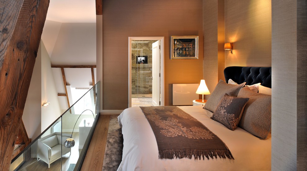 Design ideas for a medium sized contemporary mezzanine bedroom in London with beige walls and medium hardwood flooring.