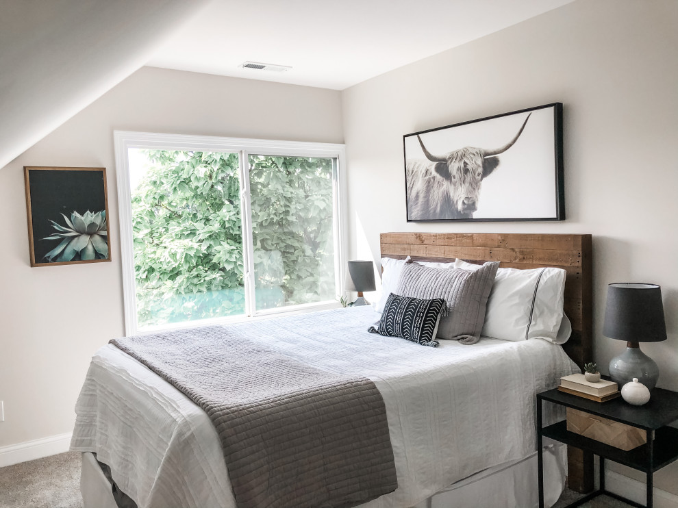 Photo of a small industrial guest bedroom in Columbus with grey walls and laminate floors.