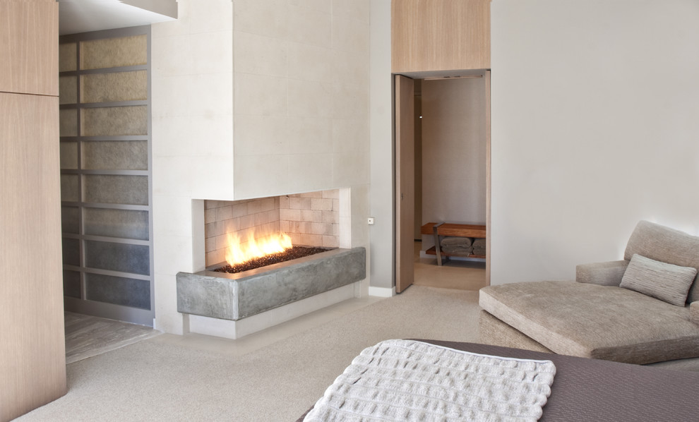 Example of a trendy bedroom design in Dallas with a concrete fireplace and a corner fireplace