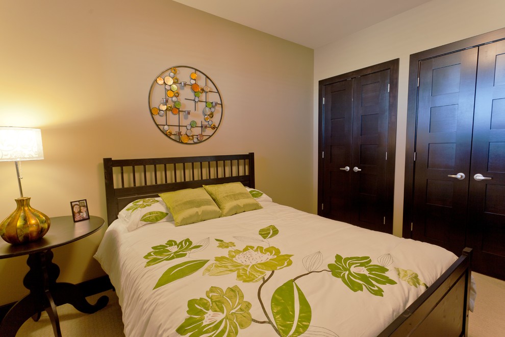 This is an example of a medium sized traditional bedroom in Calgary with beige walls and carpet.