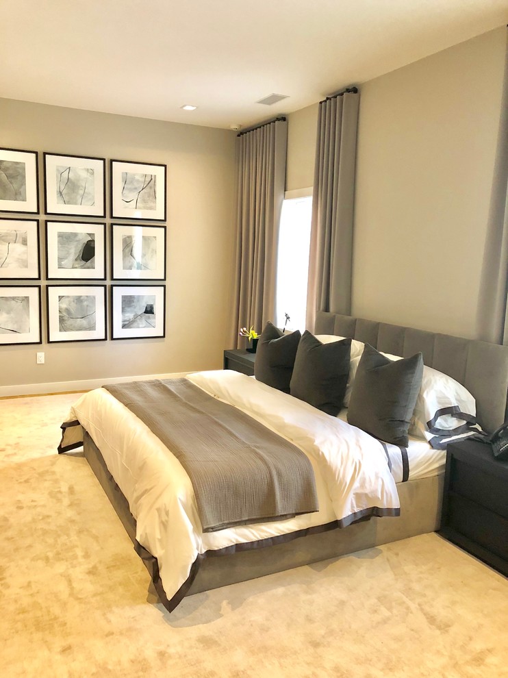 This is an example of a large modern guest bedroom in New York with grey walls and light hardwood flooring.