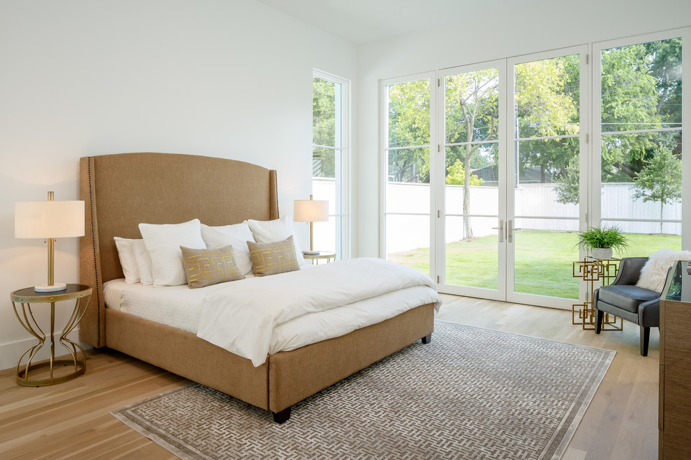 Inspiration for a large transitional master light wood floor and beige floor bedroom remodel in Dallas with white walls and no fireplace