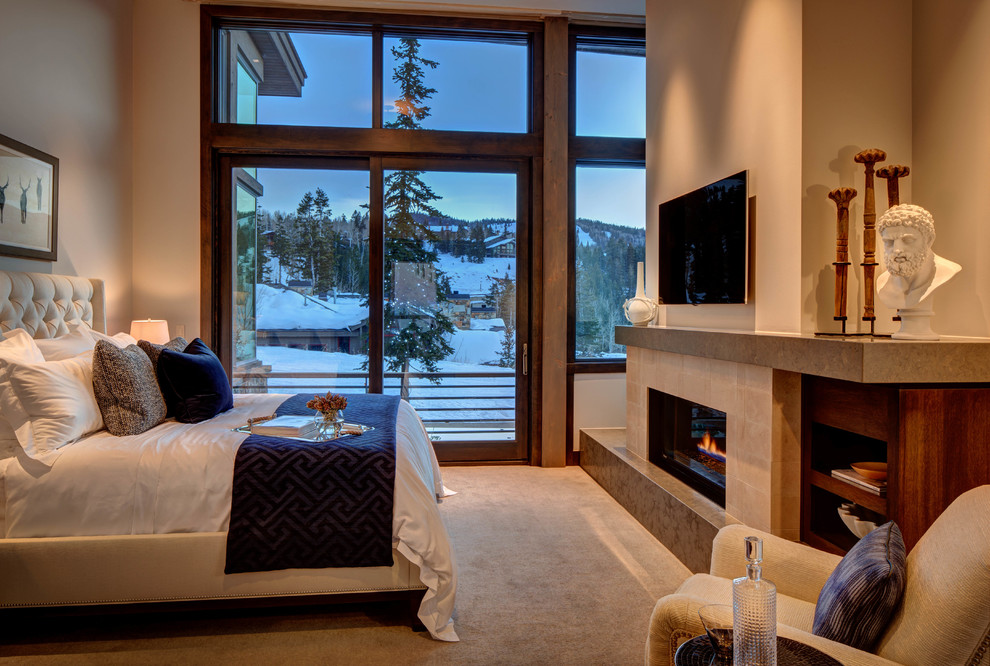 Photo of a contemporary bedroom in Salt Lake City with beige walls, carpet and a standard fireplace.
