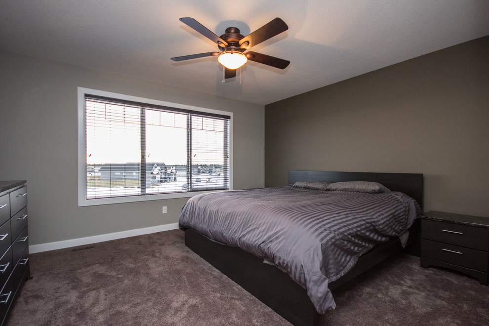 This is an example of a medium sized contemporary master bedroom in Calgary with grey walls and carpet.