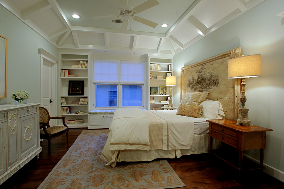 Photo of a large traditional master bedroom in Houston with blue walls, dark hardwood flooring, no fireplace and brown floors.