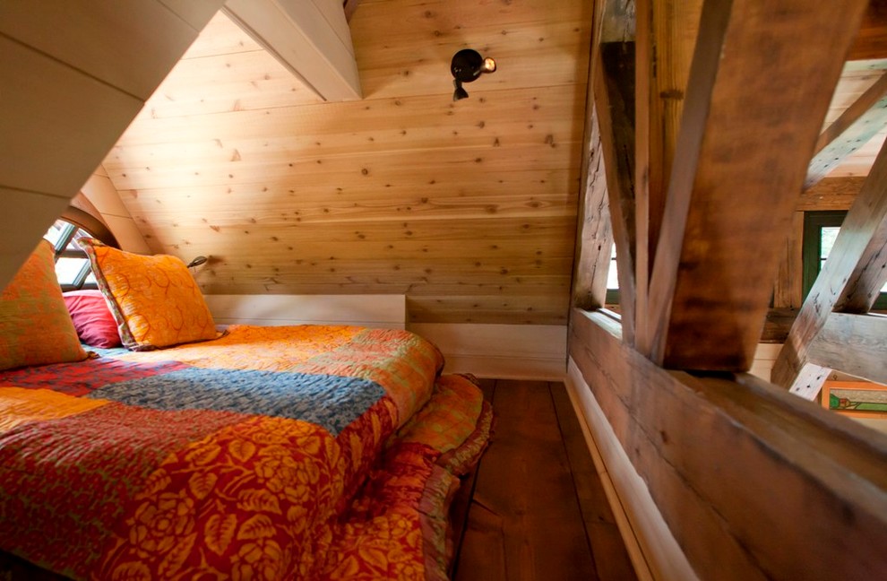 Design ideas for a small rustic mezzanine bedroom in Denver with medium hardwood flooring.