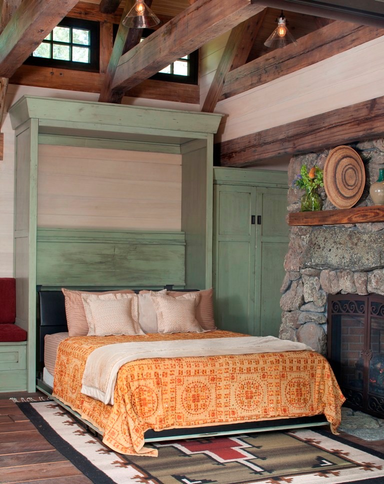 Small mountain style guest medium tone wood floor bedroom photo in Denver with a standard fireplace and a stone fireplace