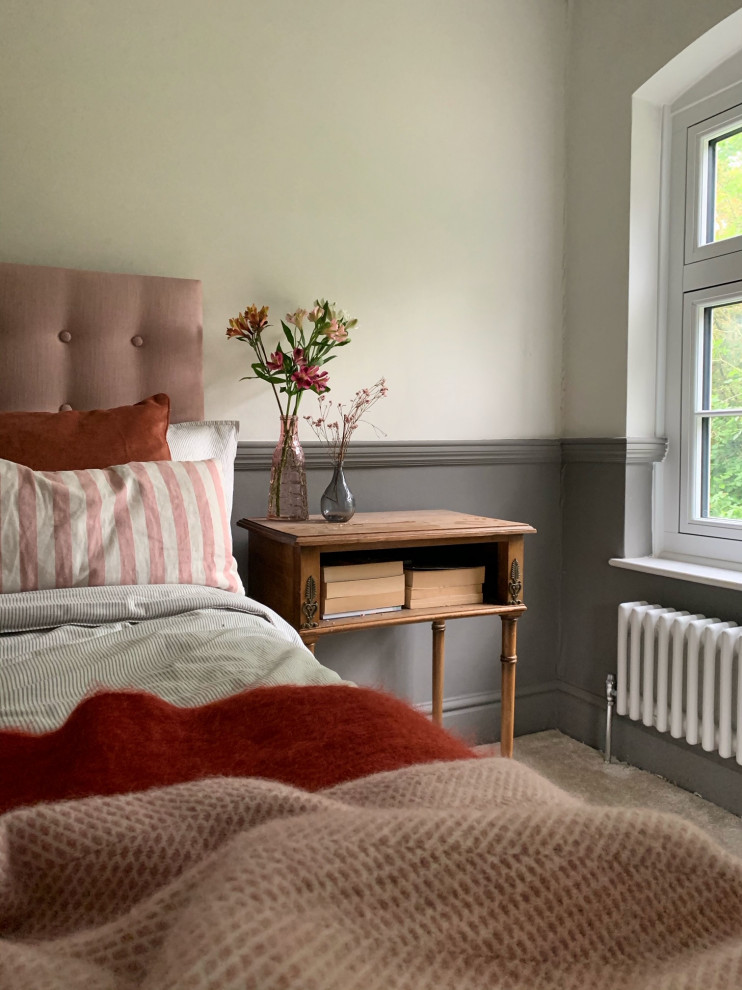 Photo of a medium sized traditional guest bedroom in West Midlands with grey walls, carpet, a standard fireplace, a metal fireplace surround and beige floors.
