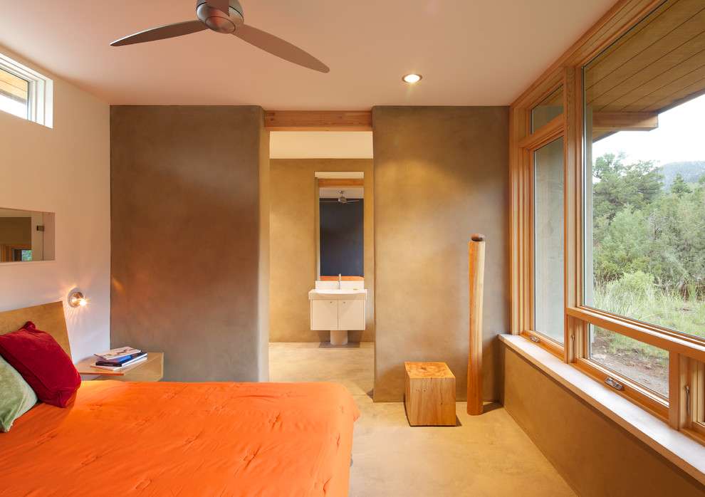 Modelo de dormitorio contemporáneo con suelo de cemento