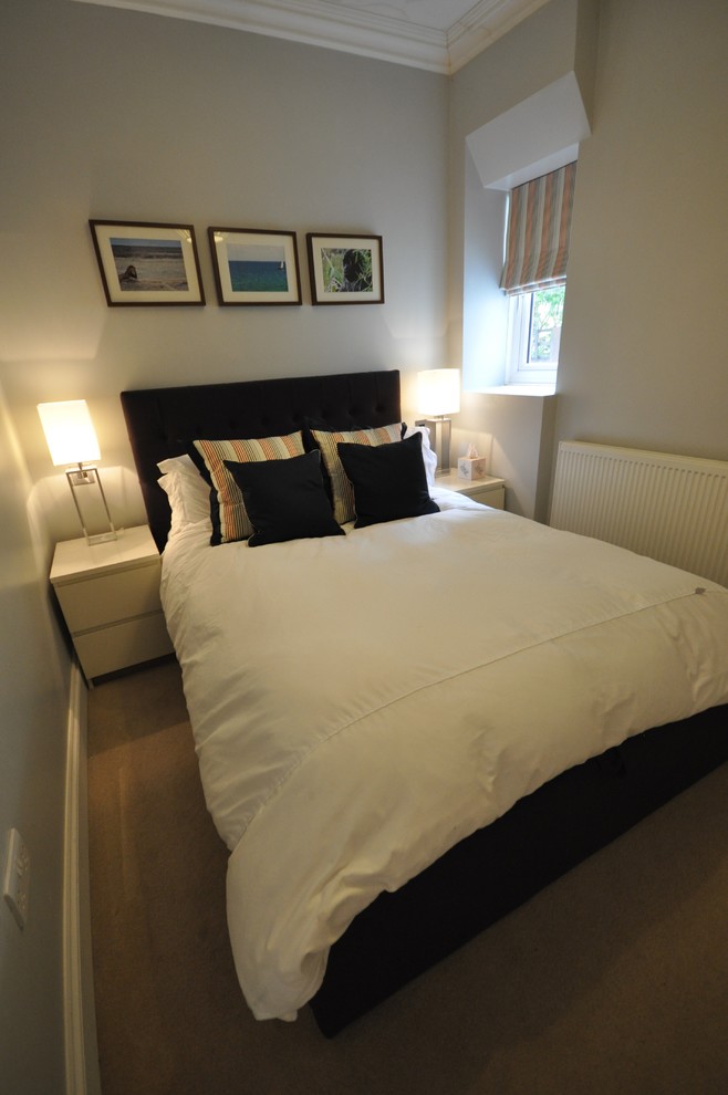 Photo of a contemporary guest bedroom in London with grey walls and carpet.
