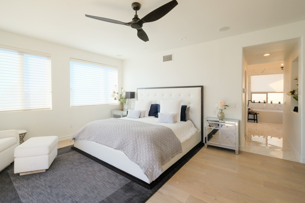 Inspiration for a medium sized contemporary master bedroom in San Diego with white walls, light hardwood flooring, no fireplace and brown floors.