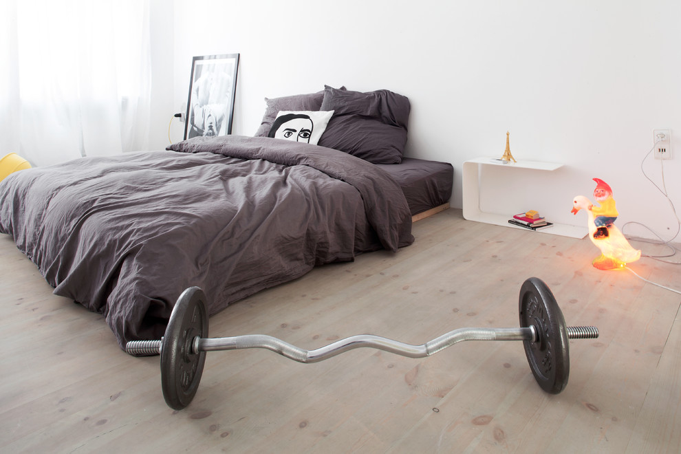 Inspiration for a mid-sized contemporary master light wood floor bedroom remodel in Berlin with white walls