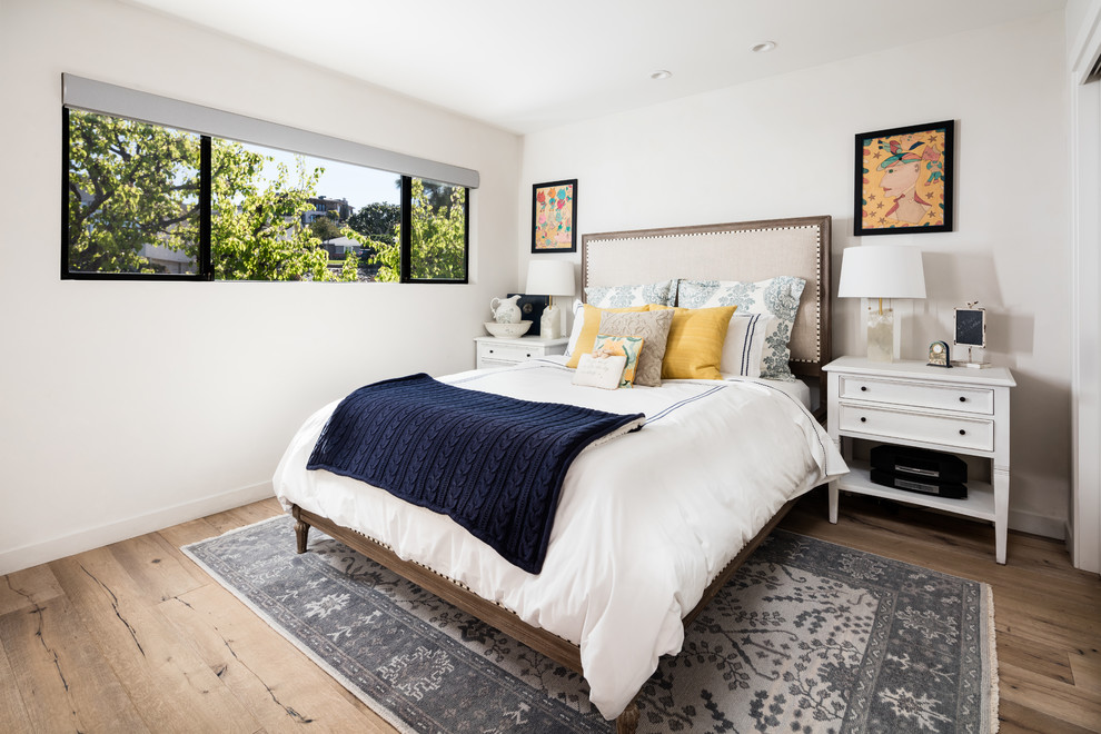 Mid-sized transitional guest light wood floor and beige floor bedroom photo in Los Angeles with white walls