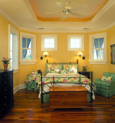 Inspiration for a mid-sized timeless guest dark wood floor and brown floor bedroom remodel in Charleston with yellow walls