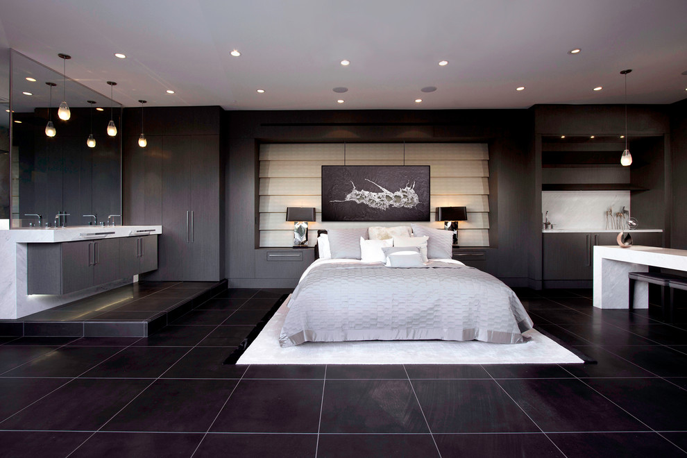 Cette image montre une chambre d'amis design de taille moyenne avec un mur gris, un sol en marbre, une cheminée double-face, un manteau de cheminée en pierre et un sol noir.