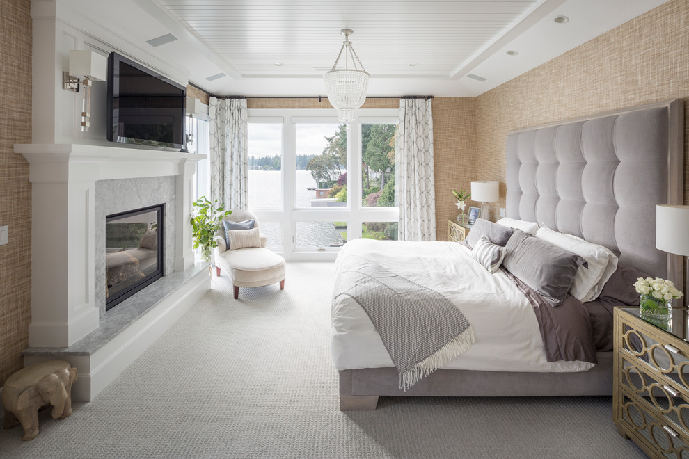 ポートランドにあるトランジショナルスタイルのおしゃれな寝室 (ベージュの壁、カーペット敷き、標準型暖炉、石材の暖炉まわり、グレーの床)