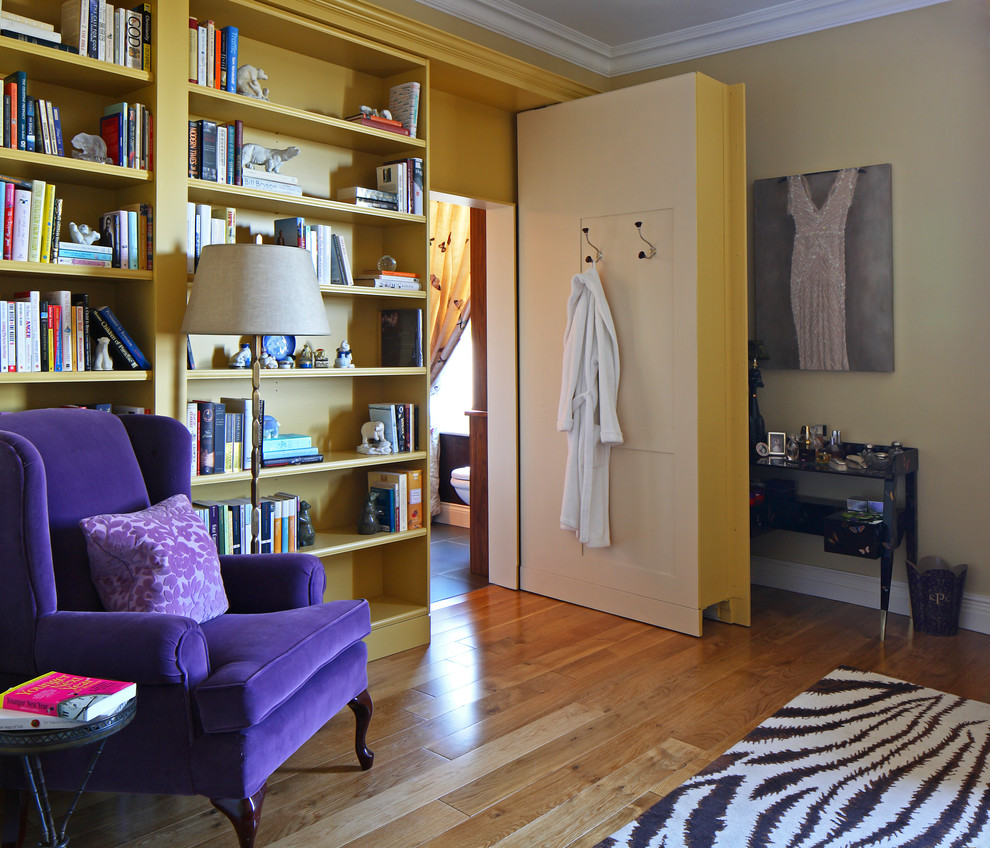 Contemporary bedroom in London with beige walls and medium hardwood flooring.