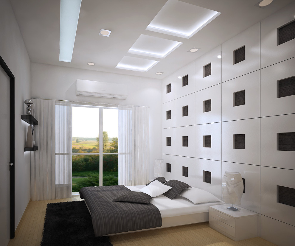 This is an example of a medium sized contemporary guest bedroom in Bengaluru with white walls and light hardwood flooring.