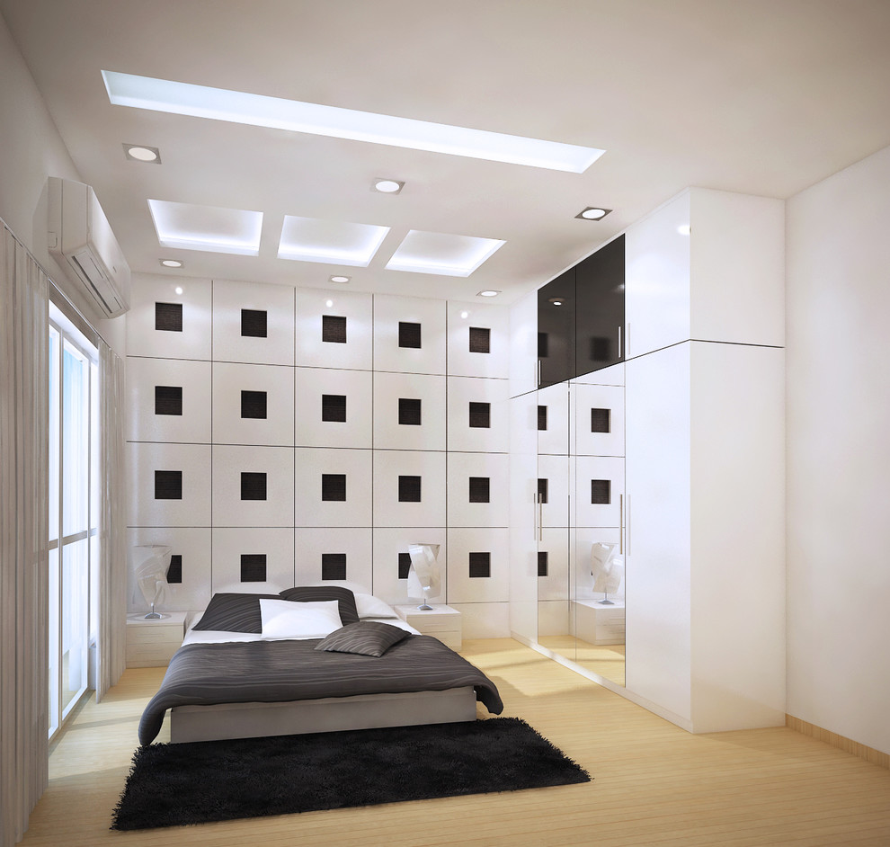 Exemple d'une chambre d'amis tendance de taille moyenne avec un mur blanc et parquet clair.