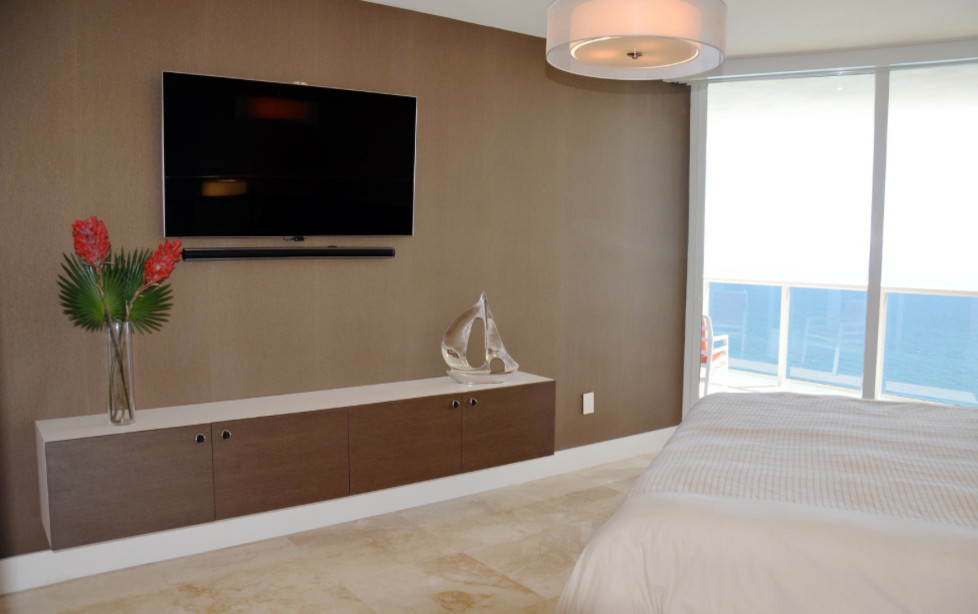 Bedroom - large eclectic master marble floor bedroom idea in Miami with beige walls