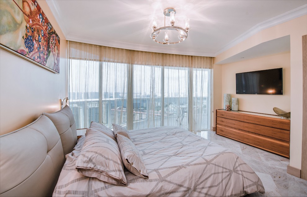 This is an example of a small contemporary guest bedroom in Miami with beige walls, marble flooring and no fireplace.