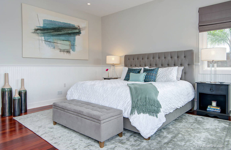 Inspiration for a mid-sized coastal guest medium tone wood floor bedroom remodel in San Diego with gray walls